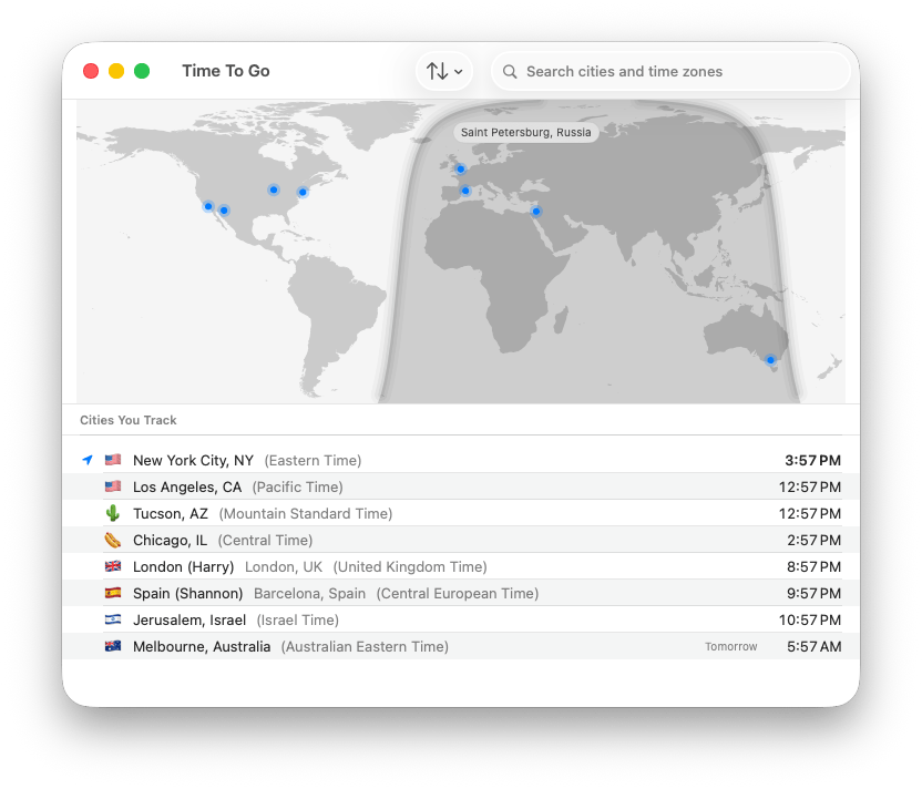The Time To Go main window: a world map with blue pins on each tracked city, a hover label reading Saint Petersburg, Russia over one pin, the nighttime half of the globe shaded, a search field for cities and time zones, a sort button, and a Cities You Track list below the map showing each city&rsquo;s flag, label, real city name, time zone, and current time