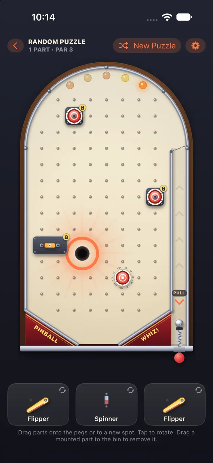 A cream-colored classic machine with locked targets and a block guarding the glowing hole, and flippers and a spinner waiting in the parts bin (iPhone)