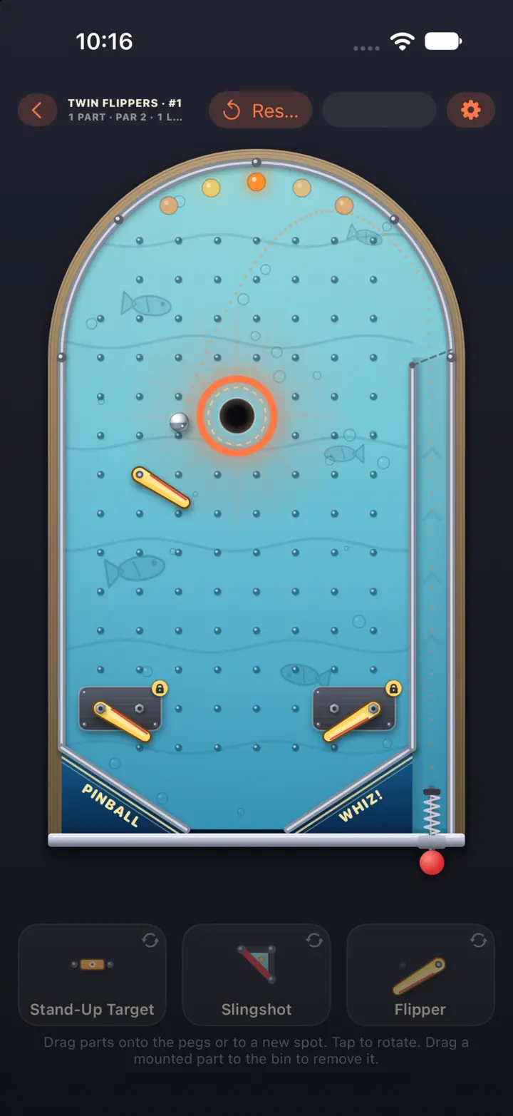 An underwater machine from the Twin Flippers pack, with fish swimming past the pegs and two locked flippers near the drain (iPhone)